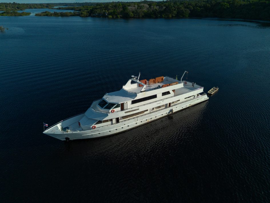 Private boat on the dark waters of the Rio Negro at sunset